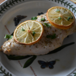 baked chicken breast with lemon and parsley on top