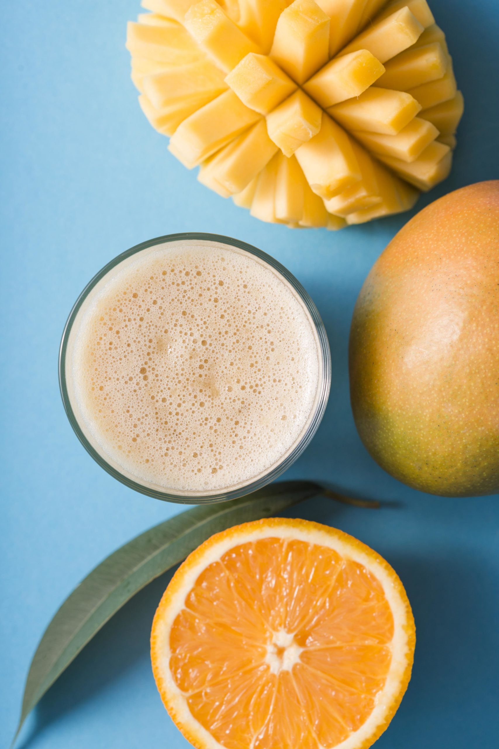 https://blog.pureindianfoods.com/wp-content/uploads/2020/11/top-view-smoothie-with-mango-orange-scaled.jpg