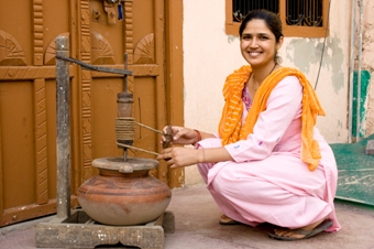 Woman Churning Yogurt To Make Cultured Butter