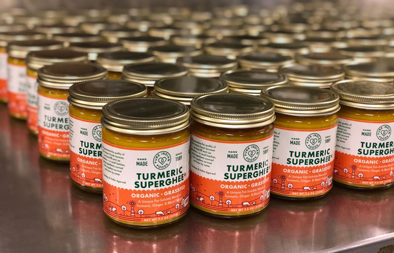 Freshly filled jars of Pure Indian Foods Turmeric Superghee, an organic, grassfed turmeric ghee infused with ginger and black pepper.